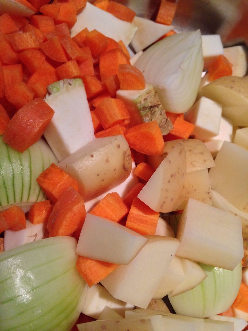 Roughly chop 2 potatoes and quarter an onion. Chop the 3 carrots into small cubes. Put all if this into a pot of water, season and  bring to the boil. Simmer until everything is soft.