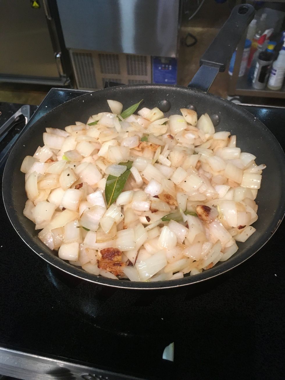Roughly chop Onions & Garlic.  Add to pan & break down until slightly soft.   Add bay leaves.