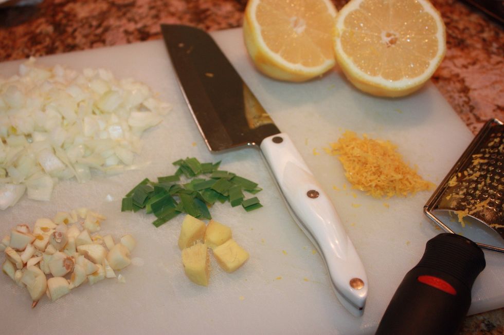 Roughly chop the onion, garlic, lemon grass, kaffir leaves, and galangal. If you do not have kafir leaves it can be substituted with lime zest. Also, the galangal can be subbed out with fresh ginger.