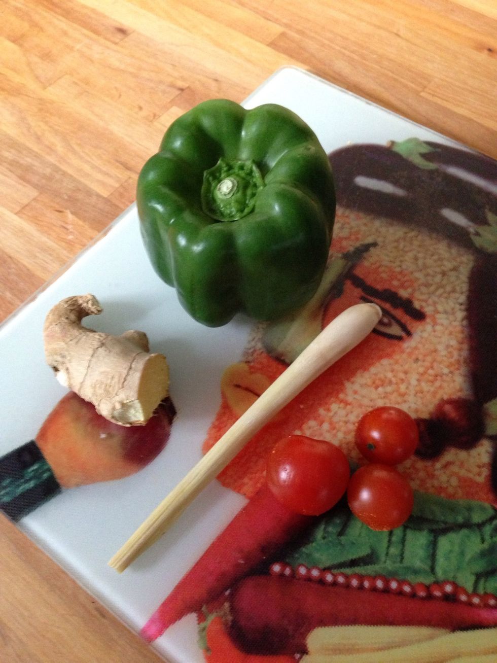 Roughly chop your bell peppers and cut your lemongrass and ginger into small pieces and add these to your roasting tray