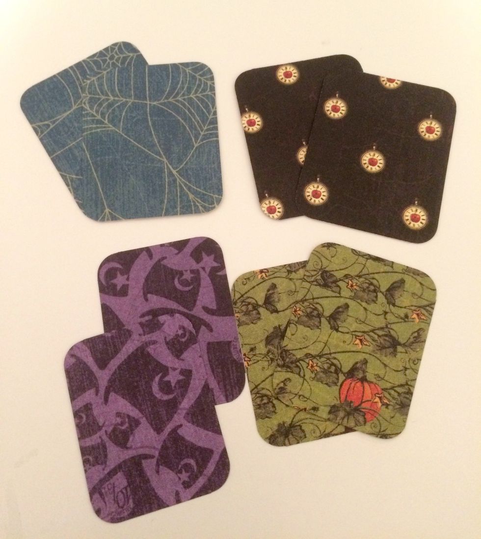 Round all the corners on the square patterned paper pieces.