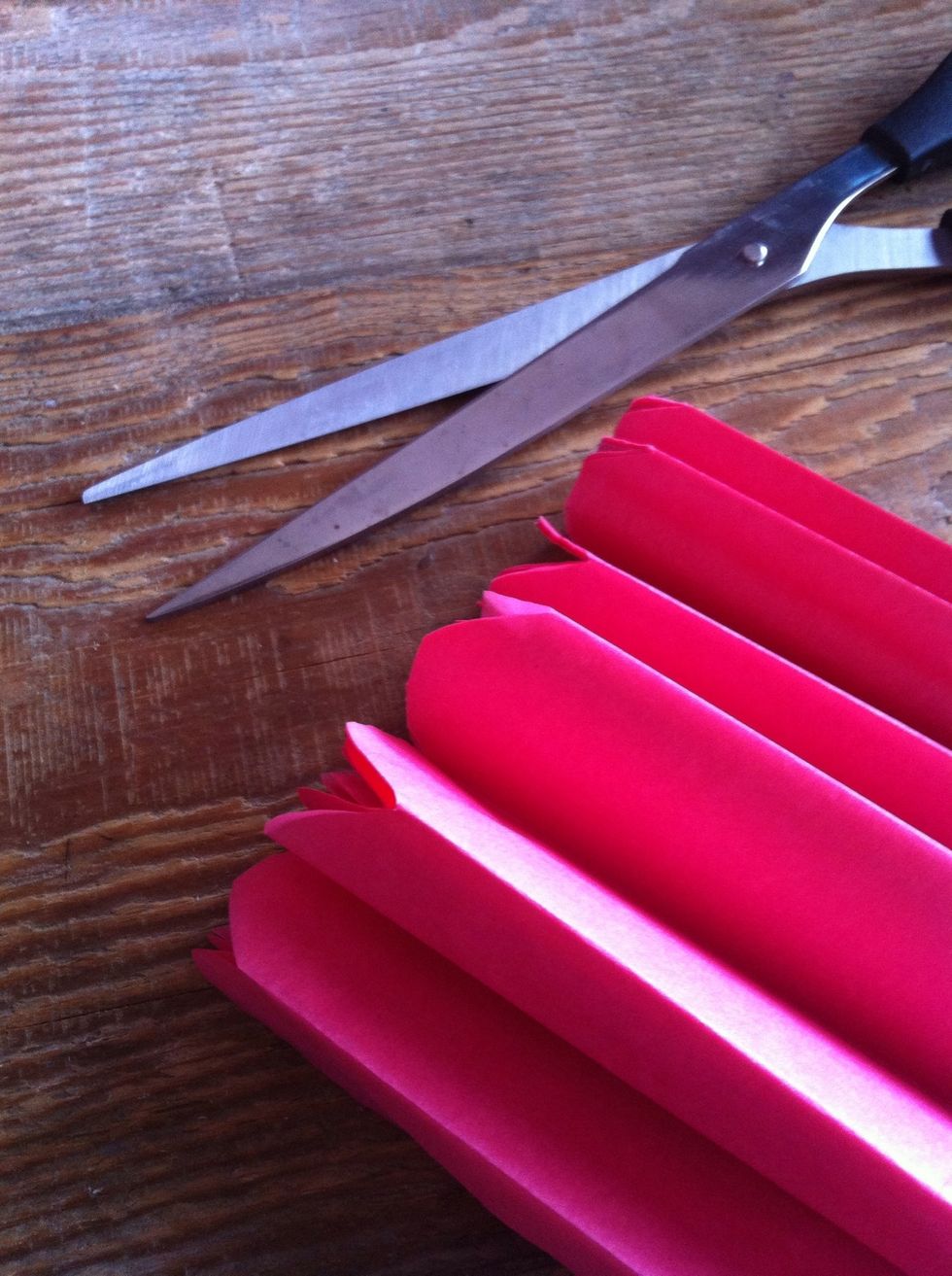 Round both edges off by cutting a semicircle. Alternatively for a more defined look, you can cut a sharper edge (V shape)