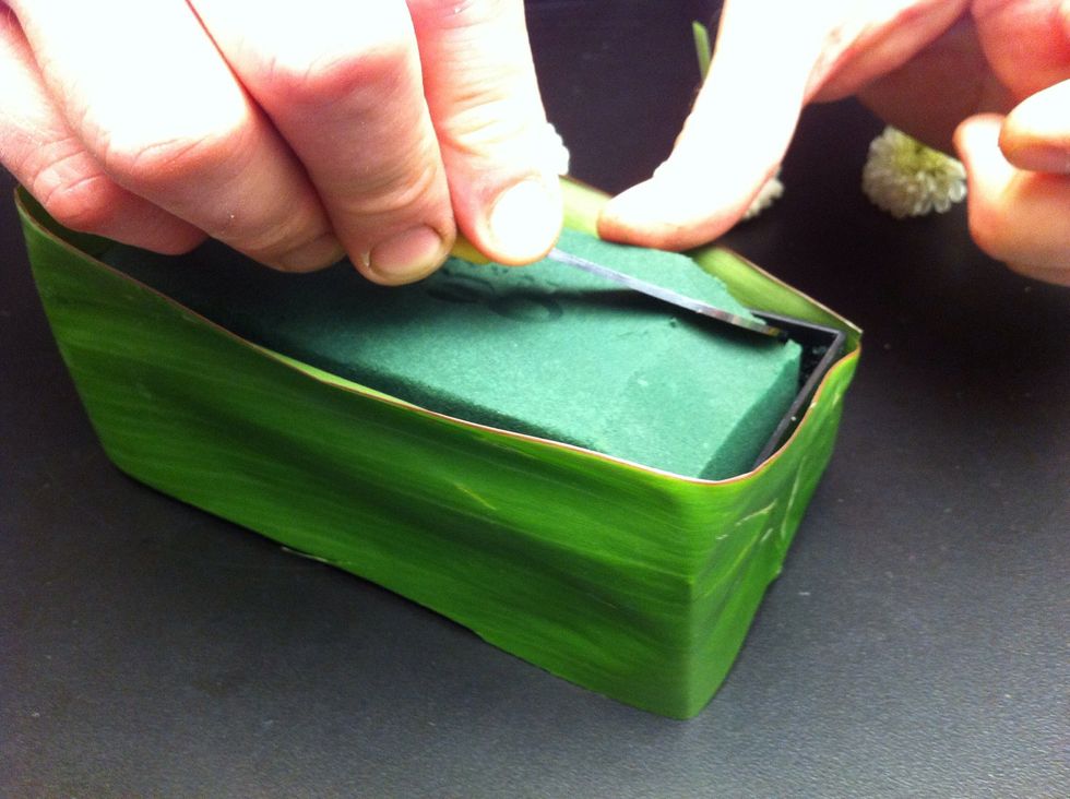 Round edges of foam using knife.