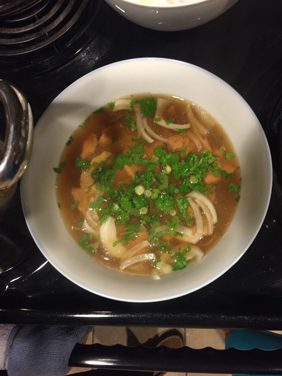 Round eye beef thinly sliced into bowl of noodles. Trim any fat off. Add cilantro, scallions, and yellow onion with the broth.