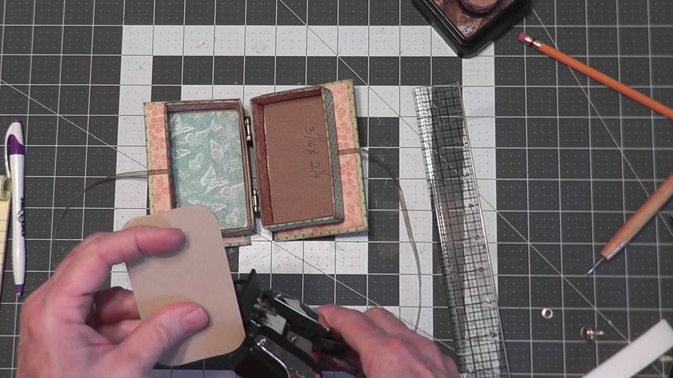 Round the corners of each section and ink the edges of the fold out pages before attaching into the box.
