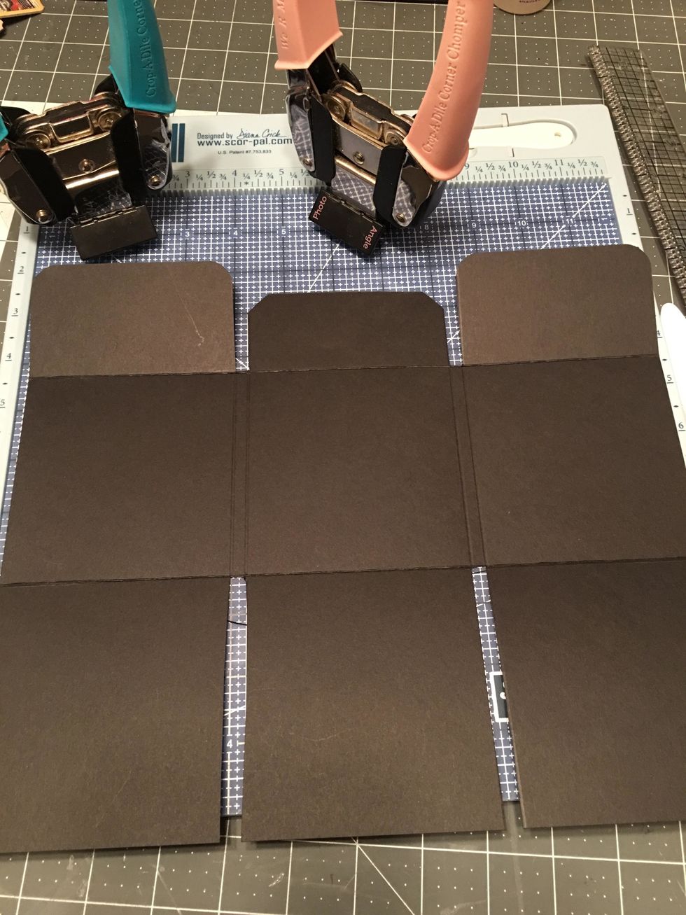 Round the corners of the left and right flaps and angle punch the center flap on the top side only.