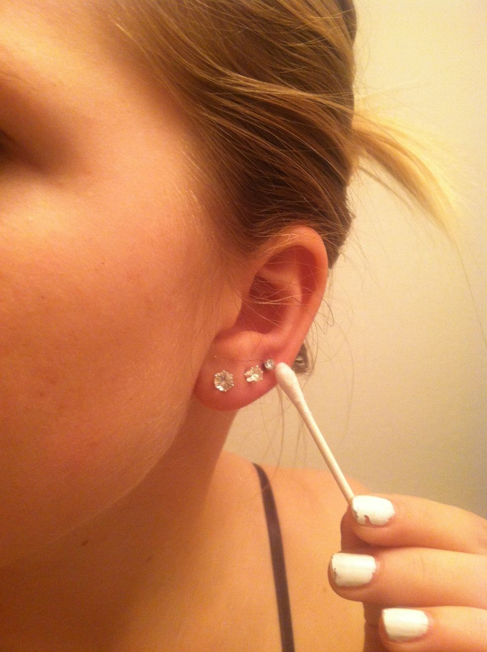 Rub around the piercing. Front and the back. This will help prevent infection.