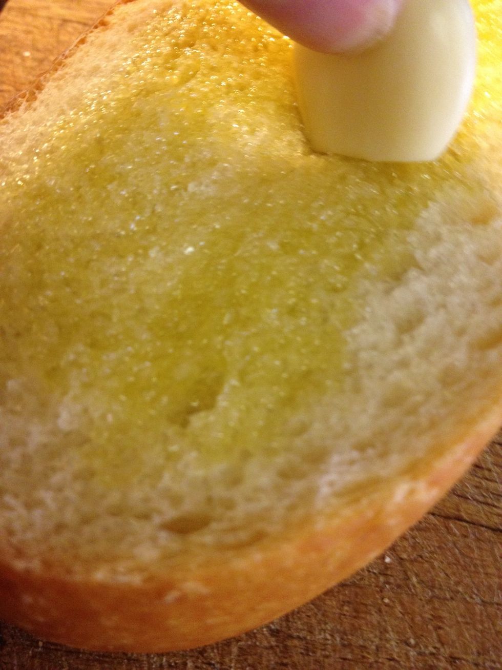 Rub bread with a clove of garlic to infuse with flavor.