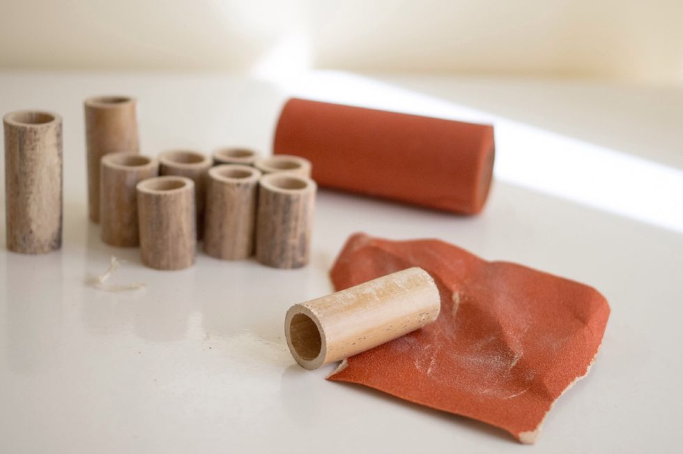 Rub down all the tubes with sandpaper until smooth. Make sure to rub down the edges.