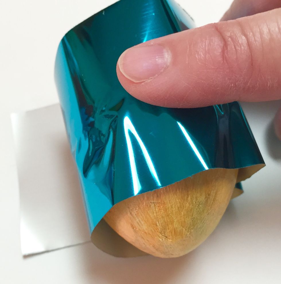 rub foil sheet over strip.