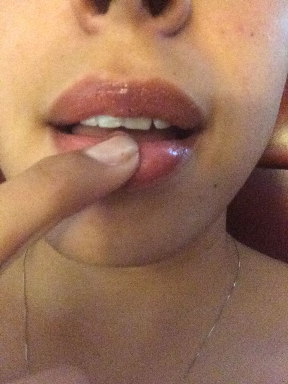 Rub it generously around your lips. After wipe it off with a damp towel.