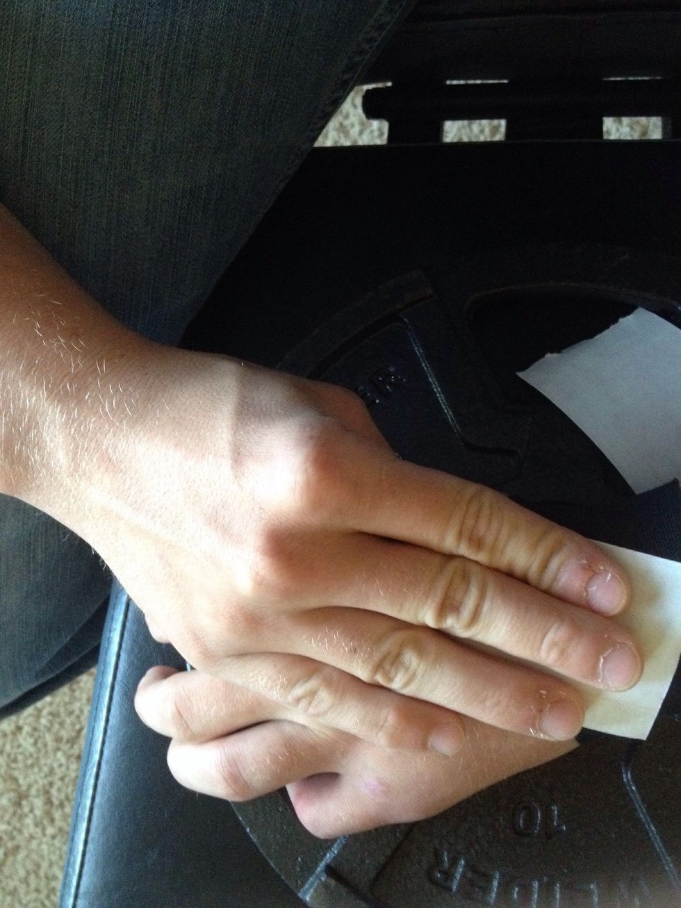 Rub the applied tape using a piece of the paper. This produces heat which strengthens the adhesive's bond to your skin and smooths out any wrinkles that may exist.