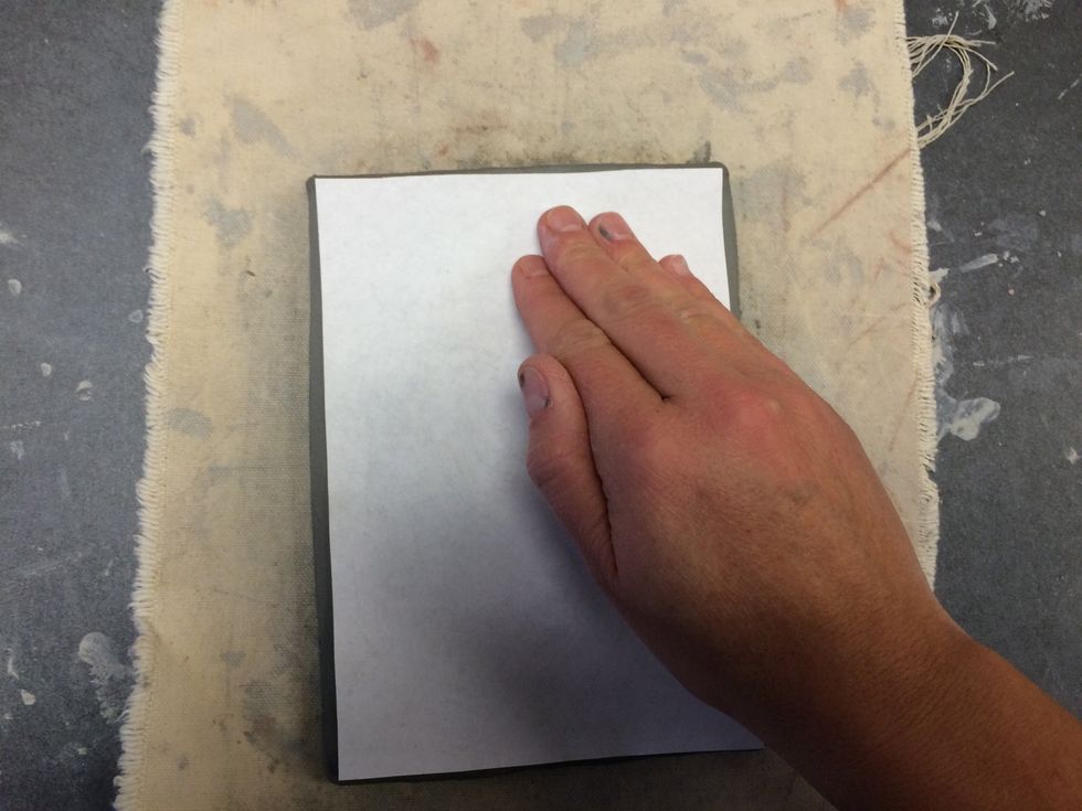 Rub the back of your photo gently from top to bottom and side to side.