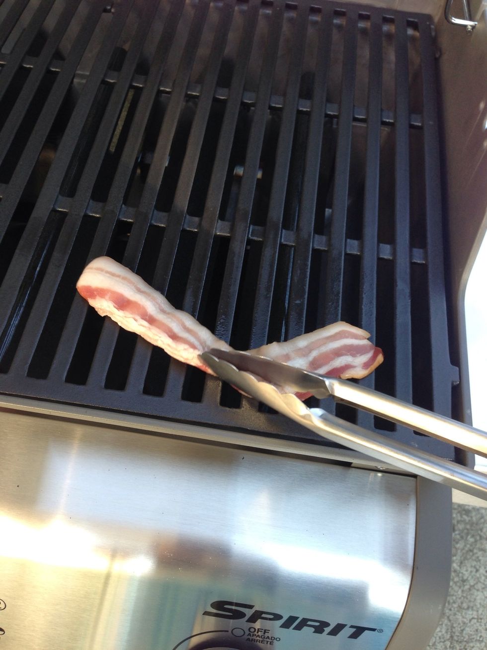 Rub the bacon over the entire cooking surface of the grill.