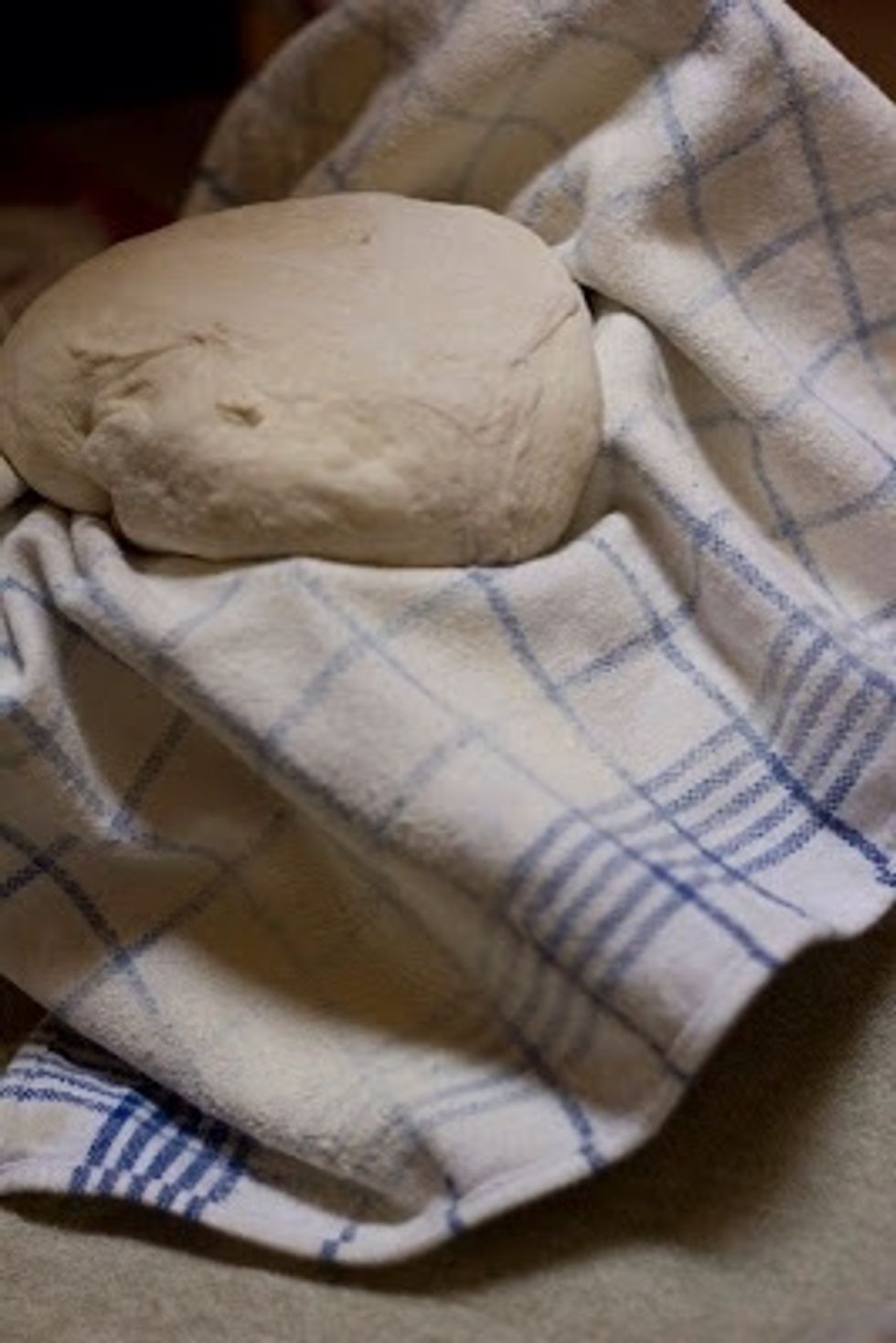 Rub the flour in well and then pick up the dough and gently lay it smooth side facing up on the dishcloth.