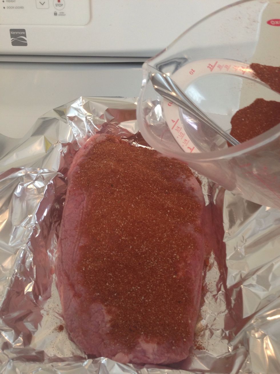 Rub the lemon juice over the top of the brisket and add the dry rub to the top.