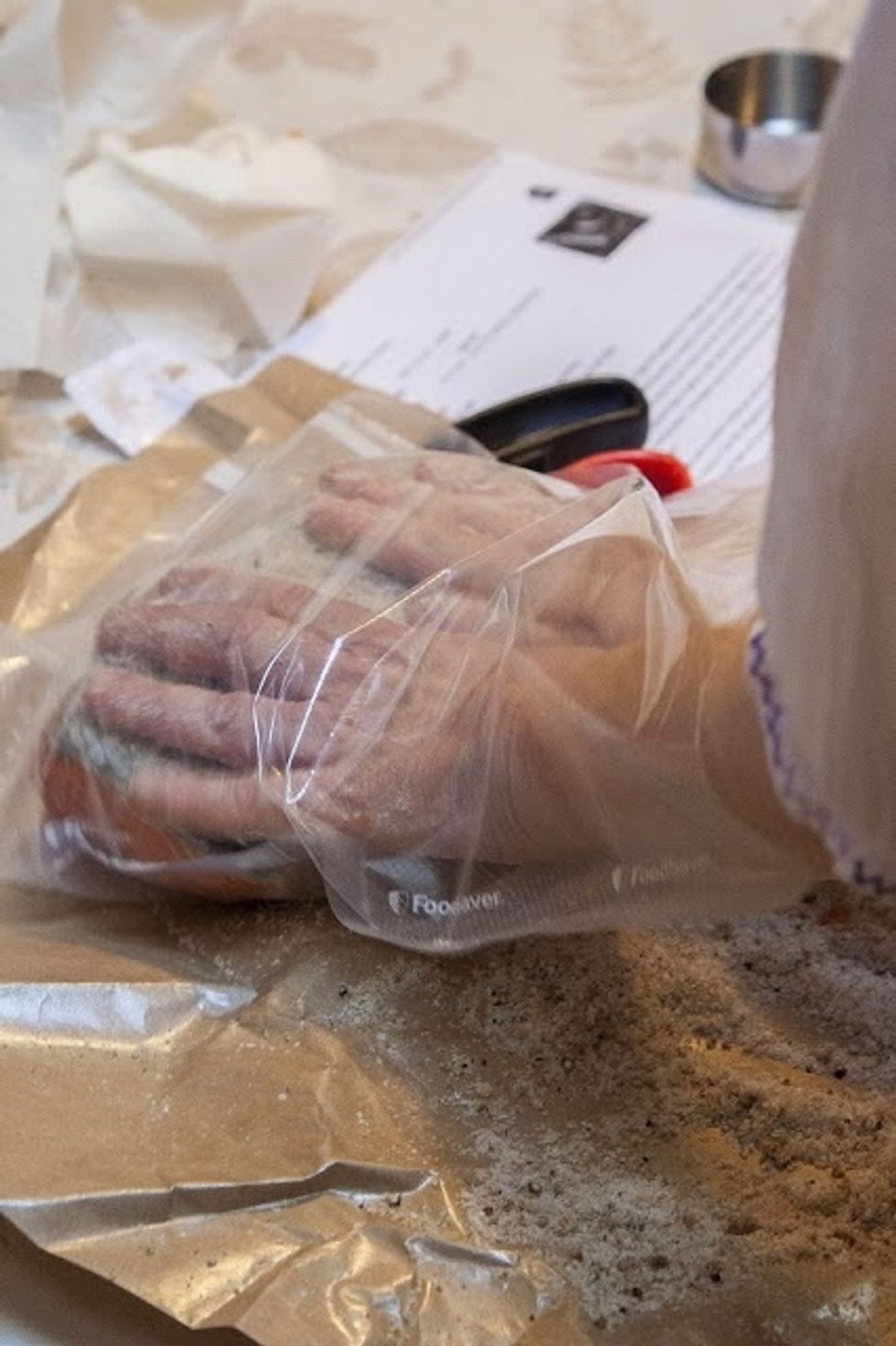 Rub the rest of the sugar and salt mixture into the skin side of the top piece of salmon. If you're using plastic wrap, wrap the fish as tightly as you can in the plastic.