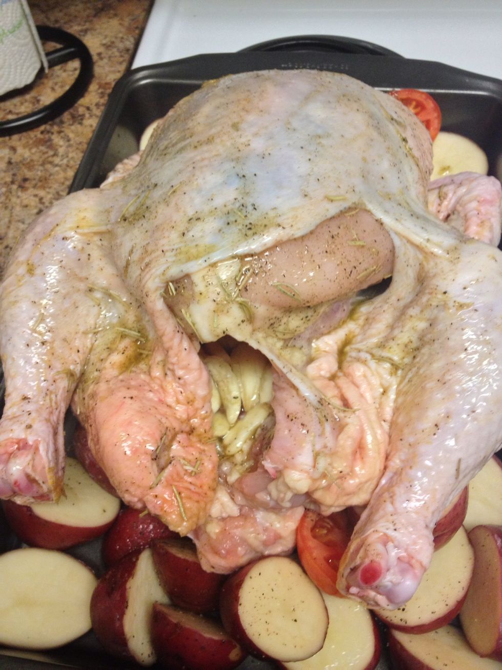 Rub your herb mixture all over the chicken. Place crushed garlic inside the chicken cavity.