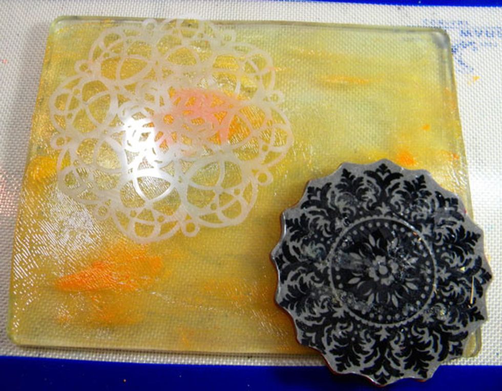 Rubber stamps are perfect to use on the Gelli Plate.  For the next print I used a large medalion stamp and the Doily stencil.