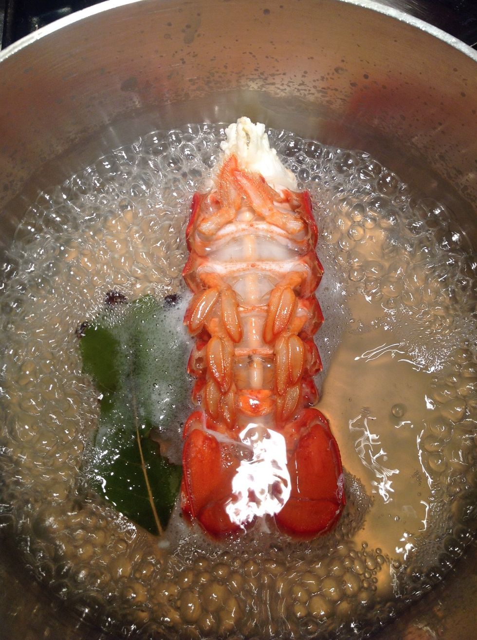 Run a bamboo skewer through the tail and add to boiling liquid.  Cook about 4 min turning once.  Set aside on plate and cool.  Save liquid for making the risotto.