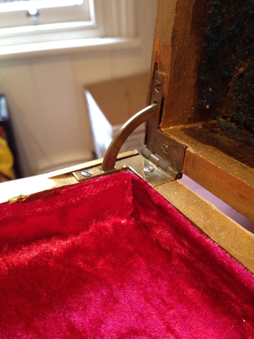 Run a line of craft glue along the top edge and the join of the floor and wall of the box. Fold over the top edge of the fabric for a neat finish