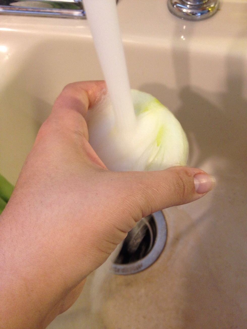 Run onions under cold water. It will help not make your eyes water as much. Chewing gum or a mint is said to help too.
