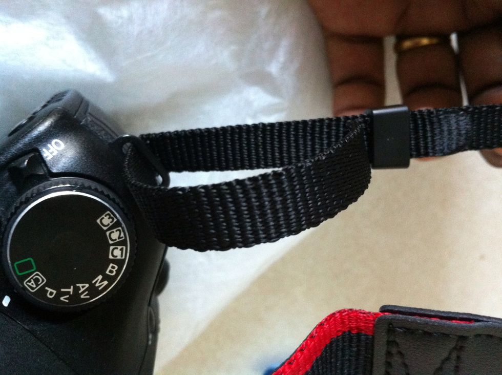 Run through the strap through the plastic holder