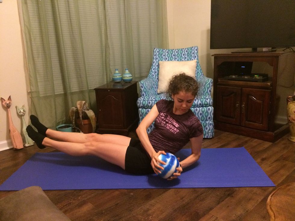 Russian Twists: Go back to the starting position. Twist your body to the other side and touch the ball to the ground.