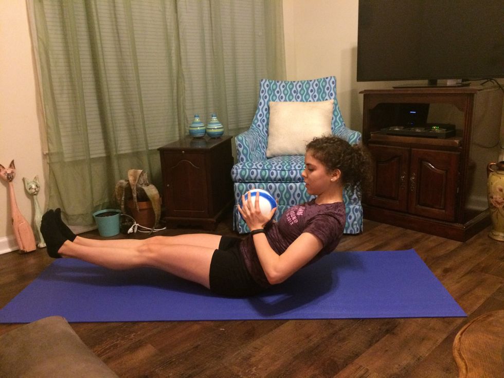 Russian Twists: Sit back as far as you can with your legs lifted above the ground. Hold the ball in front of you.