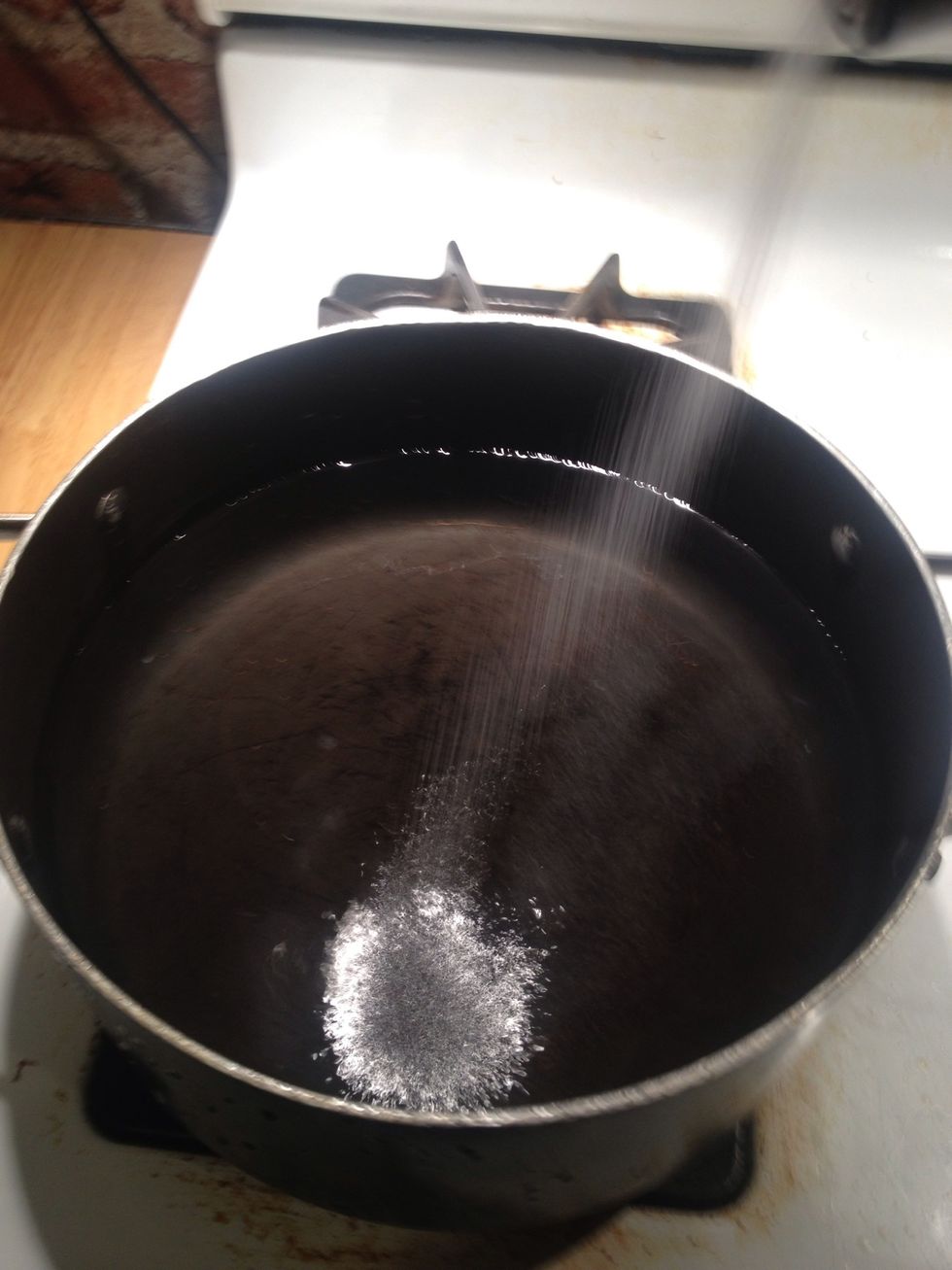 Salt boiling water to blanche green beans.