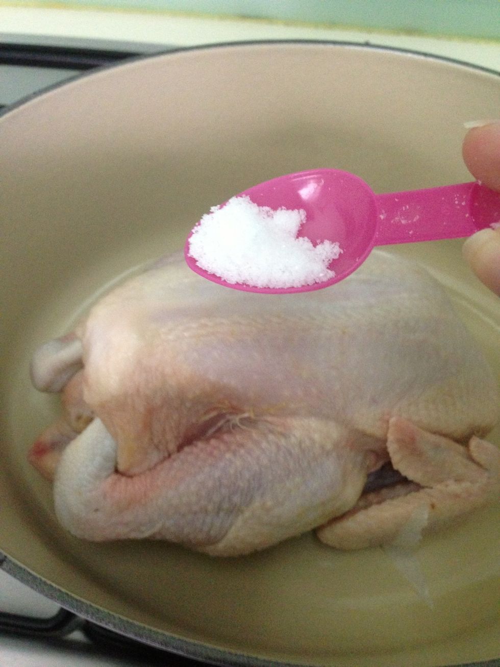 Salt it generously. Then rub olive oil on the entire chicken