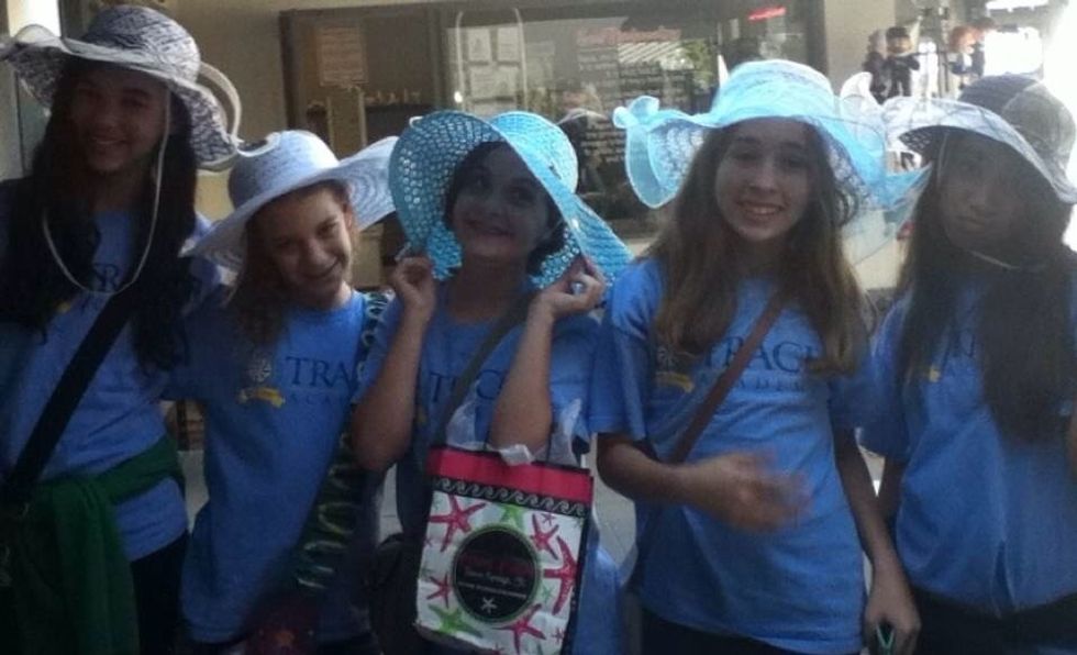 Same field trip. Trying on hats at a store