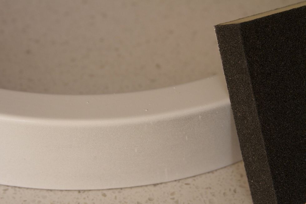 Sand away any excess paint blobs and spray again until you get a solid, uniform white exterior frame.