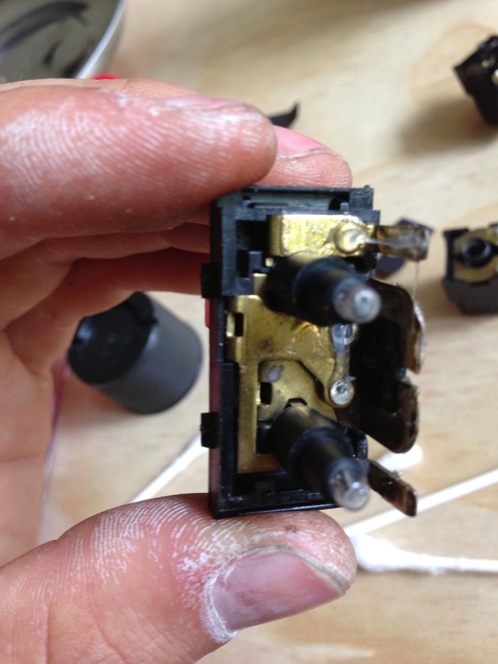 Sand the corresponding contacts on the switch side and grease them as we'll. You can see where the button contacts if you place the button back on. Be careful not to damage the light bulbs!