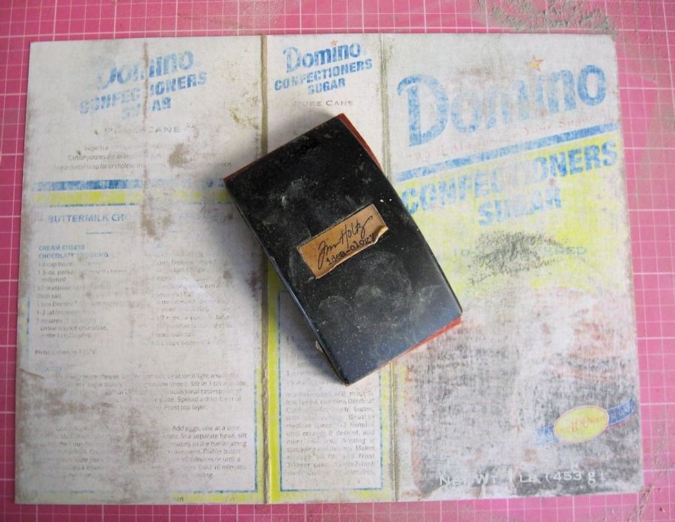 Sand the painted side of the box to create some "tooth." You don't have to sand all the way through to the kraft base, however.