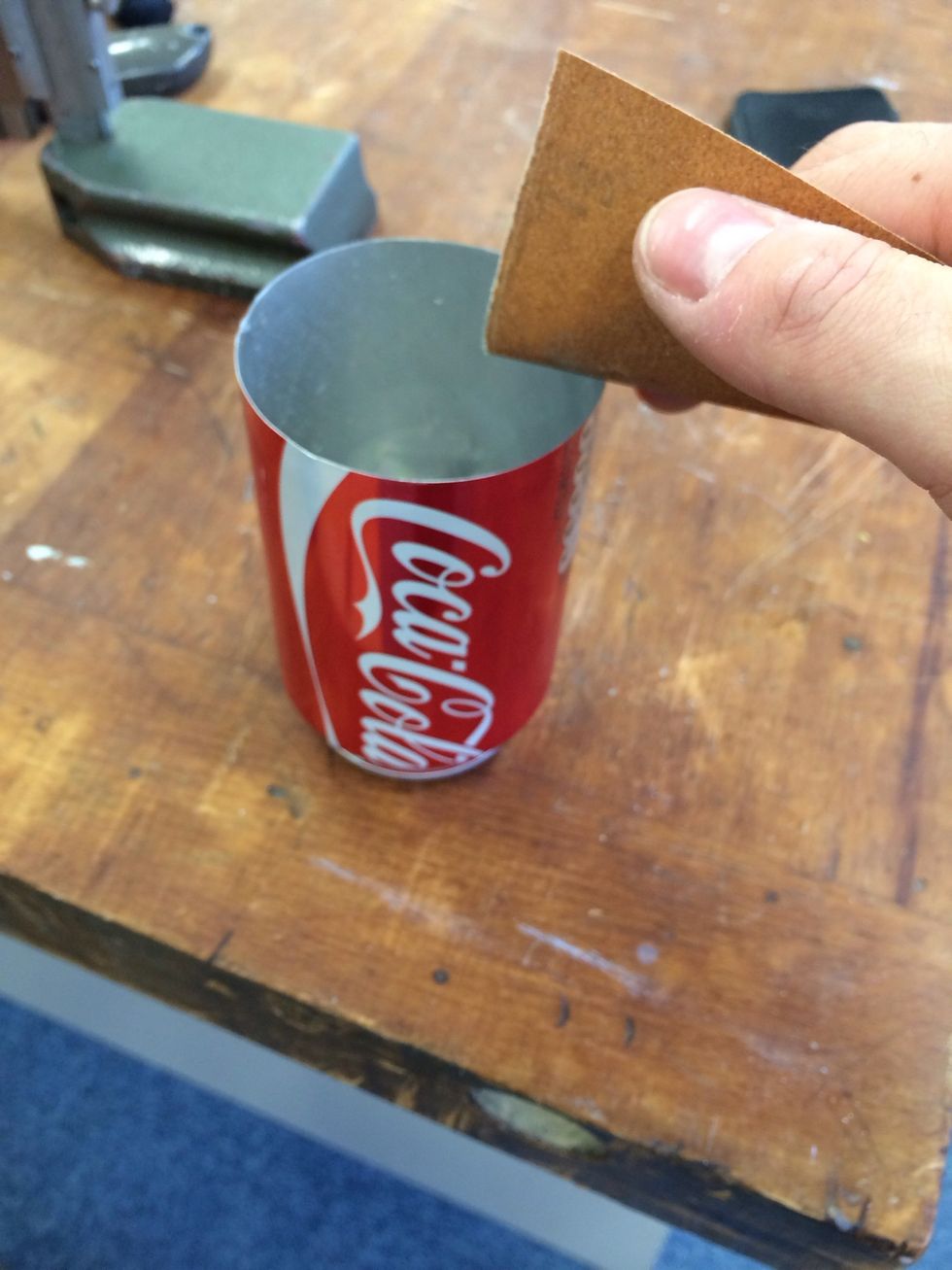 Sand the sharp burr of the can smooth on the inside and outside. Be careful to not remove any of the cans paint or you will see it!