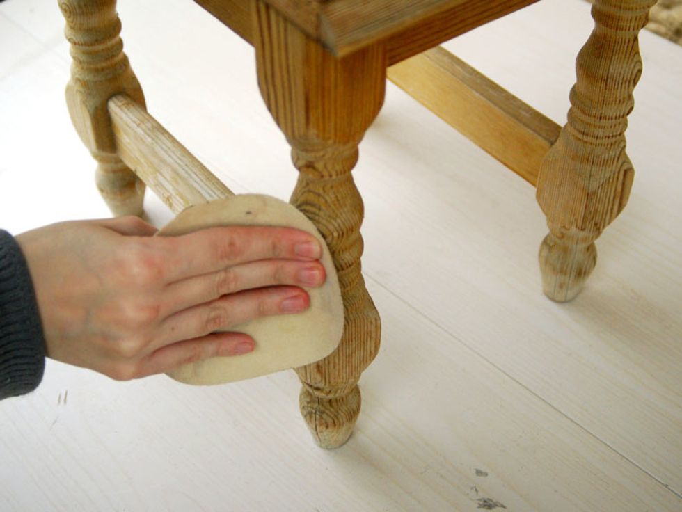 Sand the stool legs with sandpaper