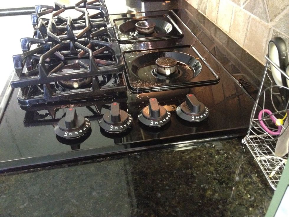 Saturate the surface and grills with the solution. Try not to puddle it in the burners or your igniter will fail. Allow it to sit for a while, but don't let it dry out. Go and have that tea.