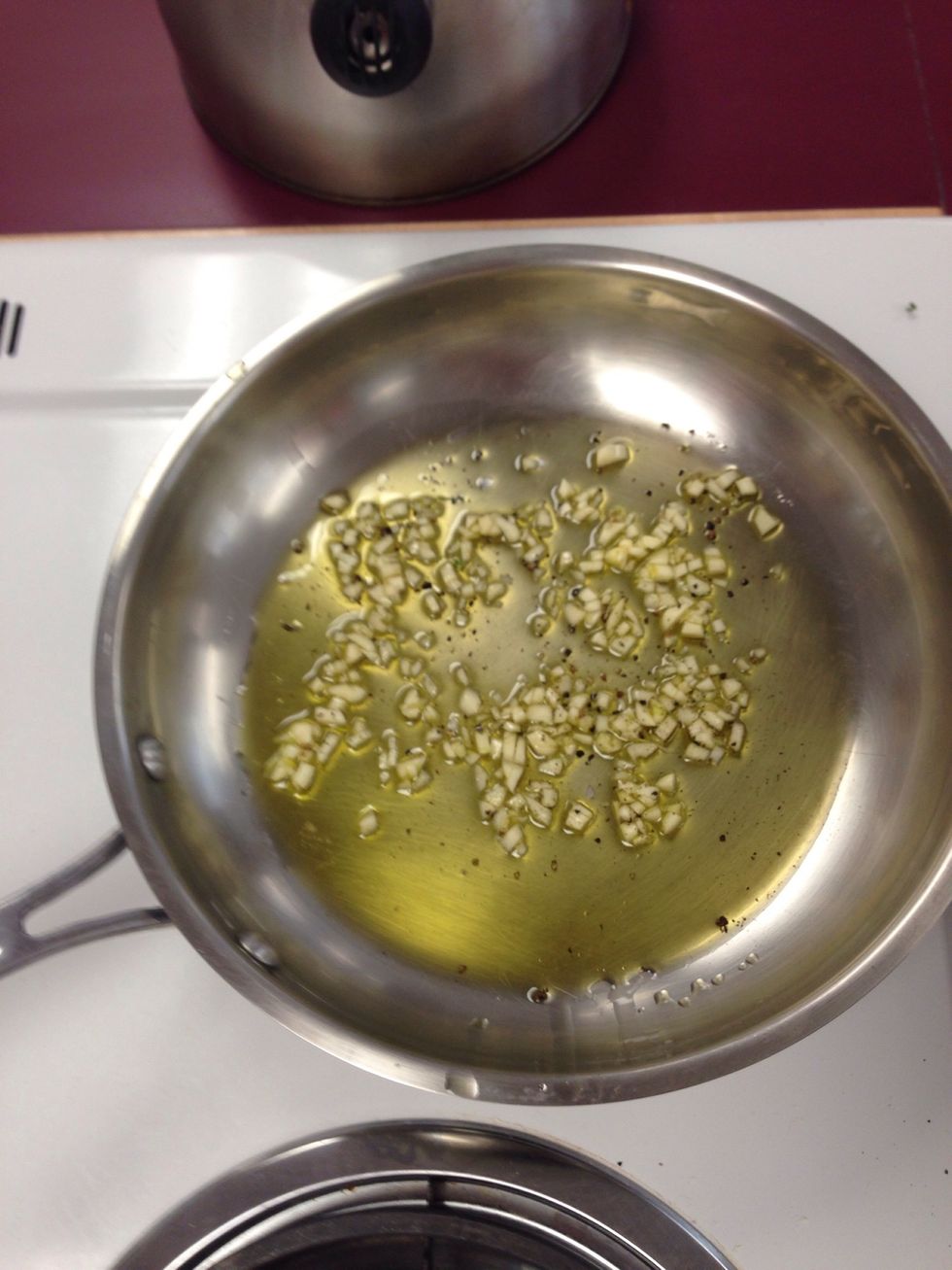 Saut\u00e9 4 new cloves of garlic in 3 tablespoons of fresh olive oil. We added a little black pepper for taste