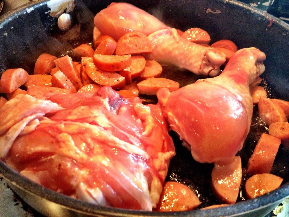 Saut\u00e9 6 legs & 6 chicken thighs with sausage for six minutes, turning chicken after about 3 minutes.