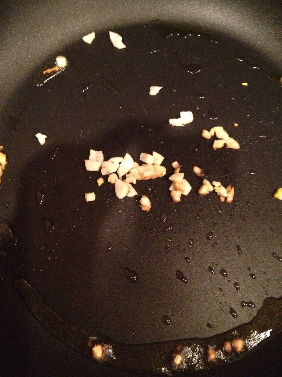 Saut\u00e9 extra virgin olive oil and garlic in large Saut\u00e9e pan.