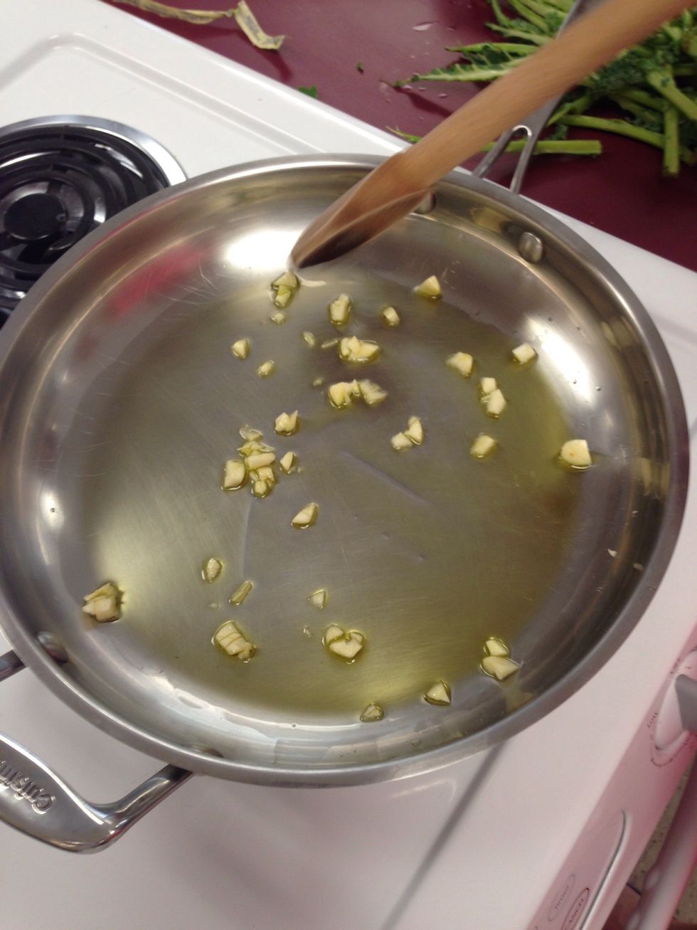 Saut\u00e9 garlic cloves in 2 tablespoons of olive oil