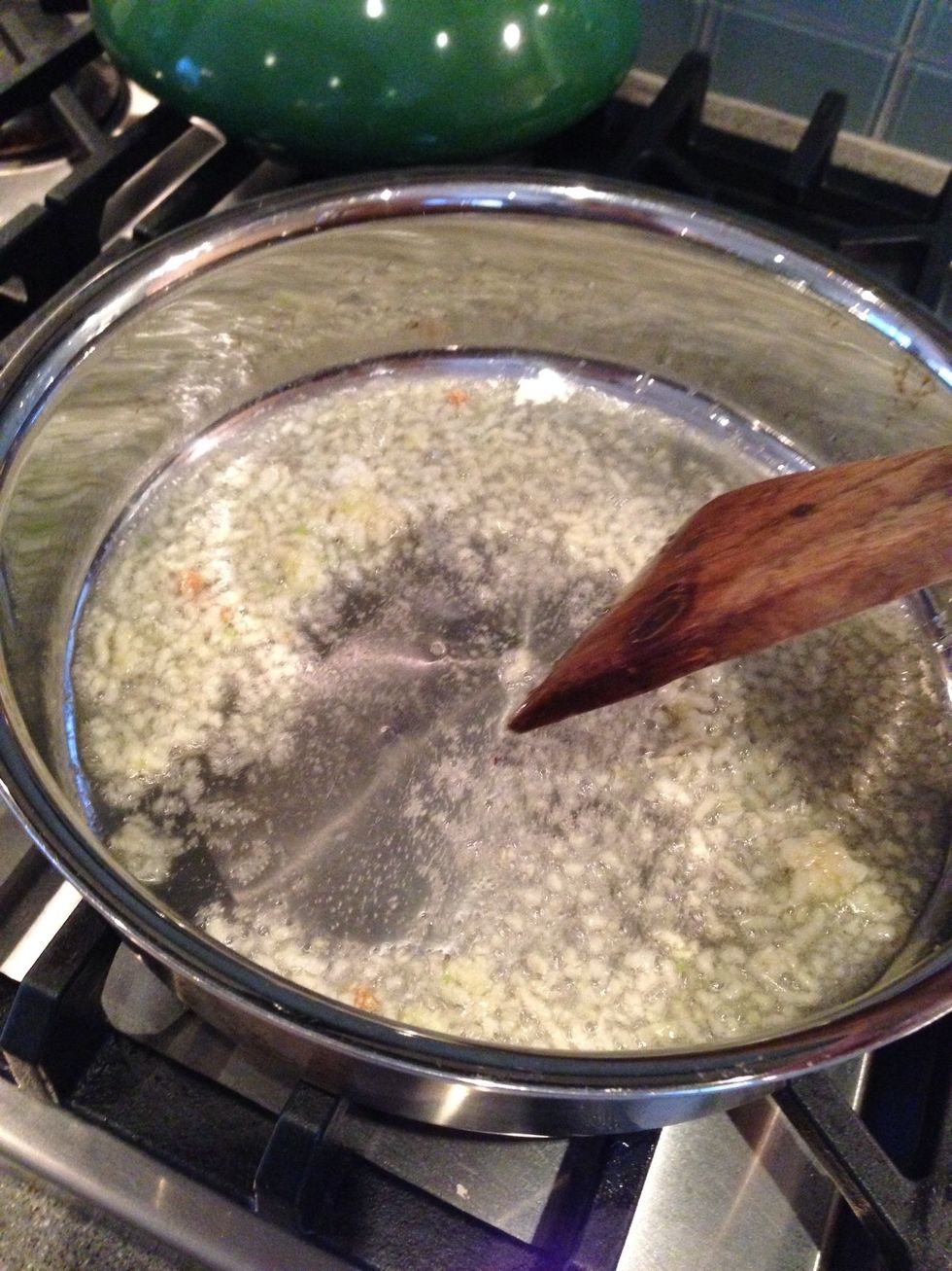 Saut\u00e9 garlic for 1 minute, or until slightly golden. It will become sticky but keep stirring.