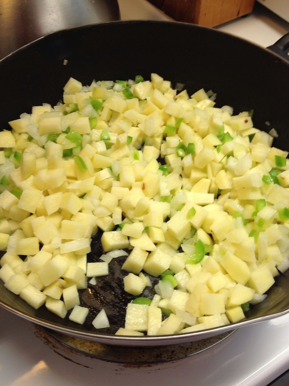 Saut\u00e9 in butter over medium high heat for about 4 minutes and then turn down heat and cook until potatoes are just about soft. Season potatoes with garlic pepper, salt and crush red pepper.
