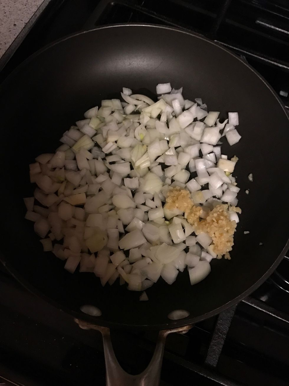 Saut\u00e9 onion and garlic with olive oil for 4 minutes