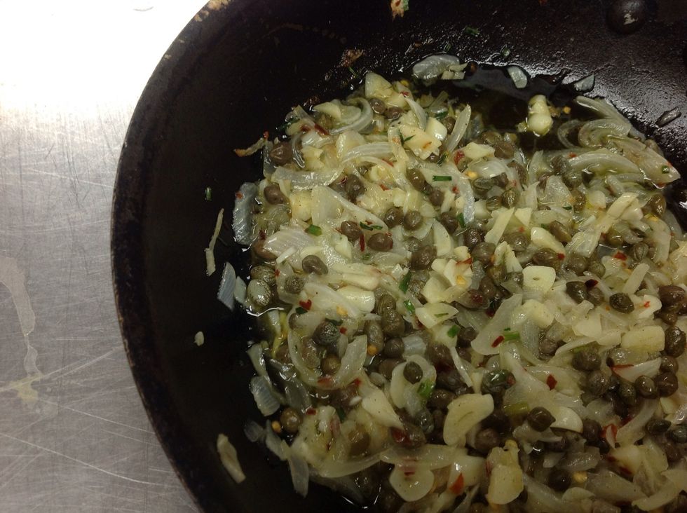 Saut\u00e9 onions, garlic, chilies and capers. Chill