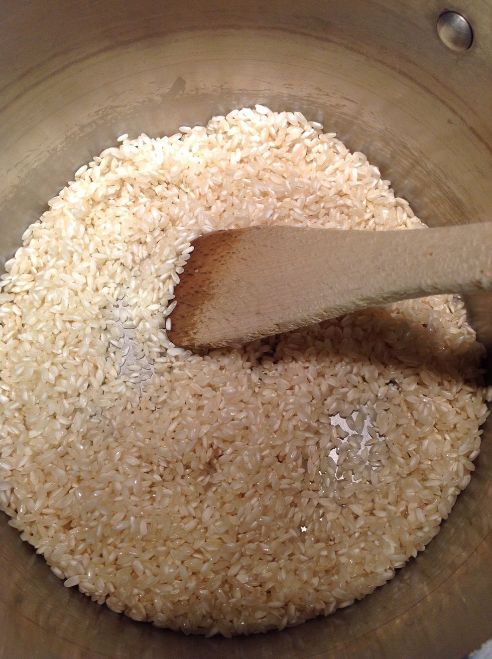 Saut\u00e9 rice until opaque in 1 tbls. olive oil add shallot until soft then make the risotto by adding liquid slowly 1/2 cup at a time until creamy and al'dente