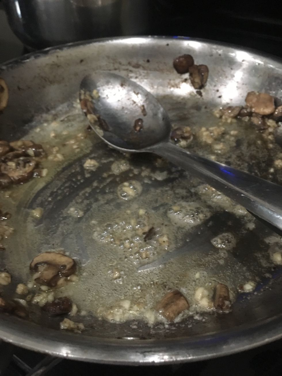 Saut\u00e9 some garlic and butter in the pan.