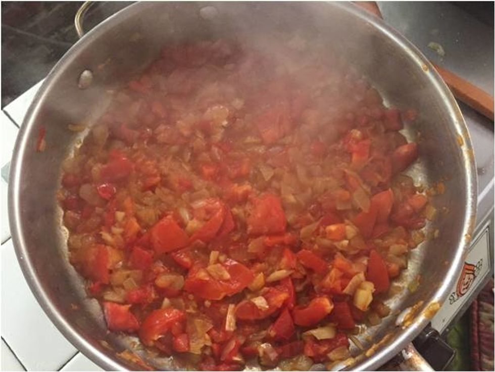 Saut\u00e9 the onions, garlic and tomatoes to make a sofrito.