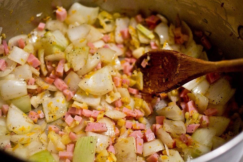 Saut\u00e9 the onions, ham, garlic, ginger and zest over medium high heat.